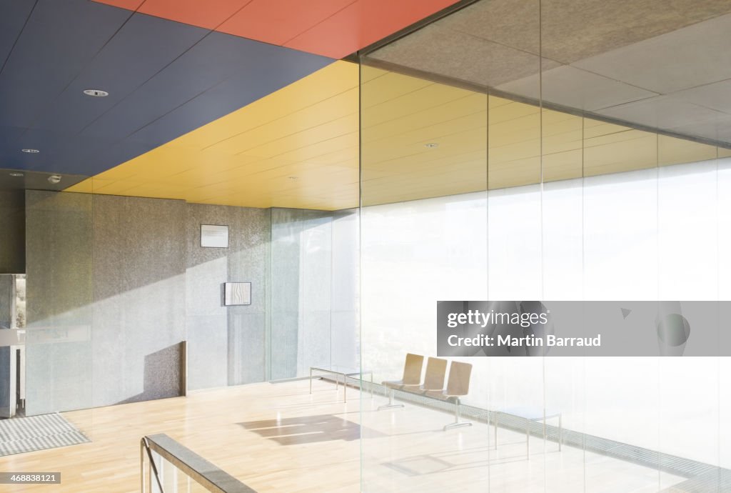 Chairs and window in sunny office lobby