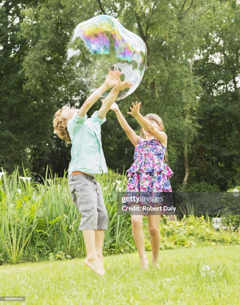 Children playing with bubble outdoors