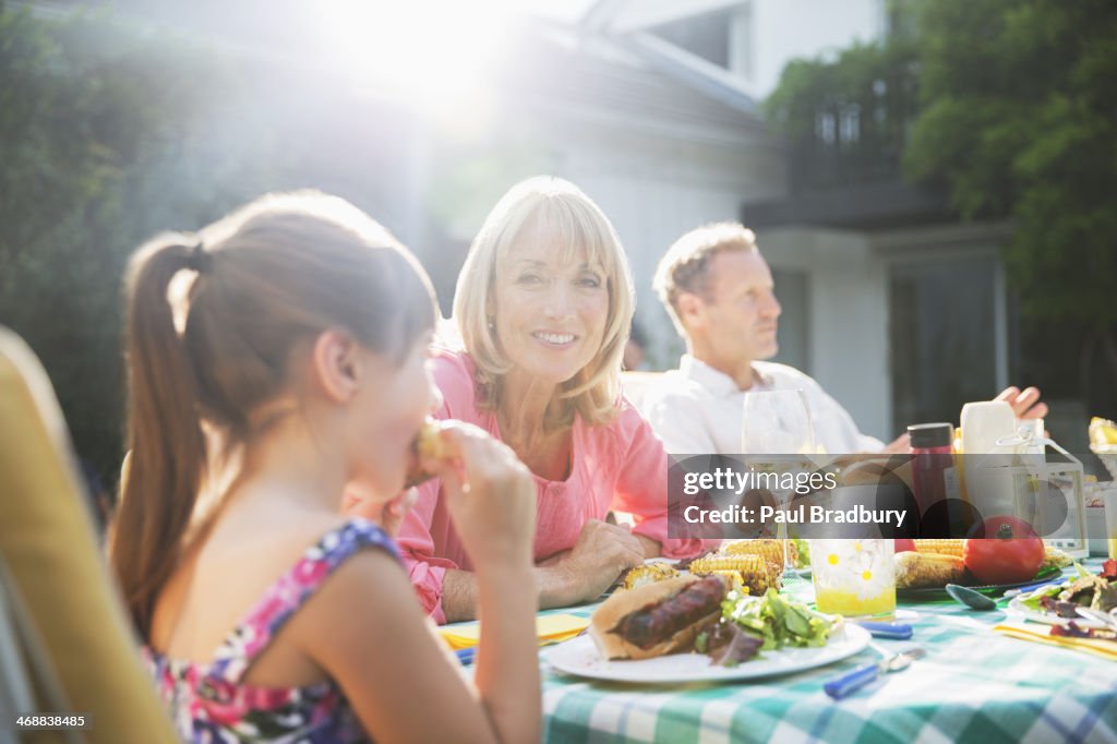 Family eating lunch at patio table