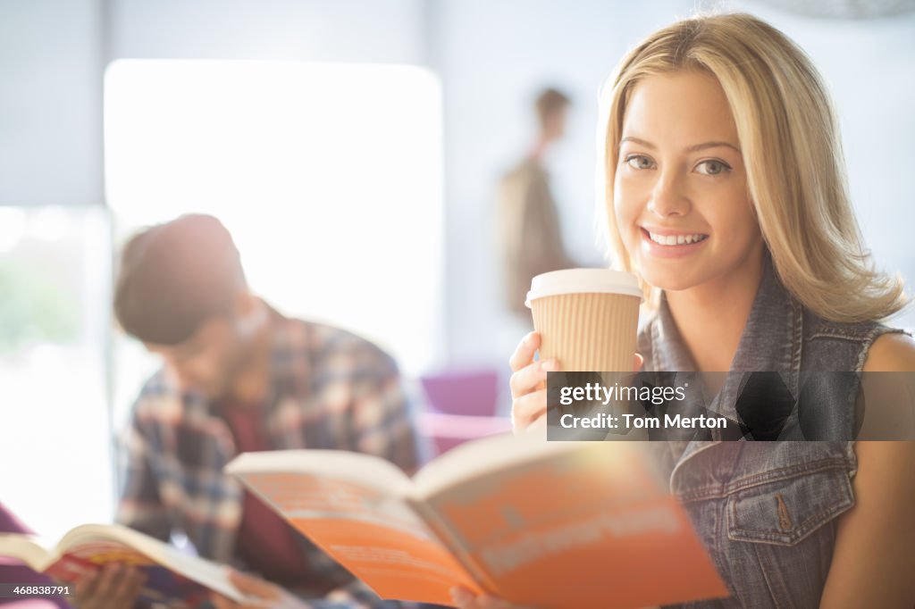 University student reading and drinking coffee