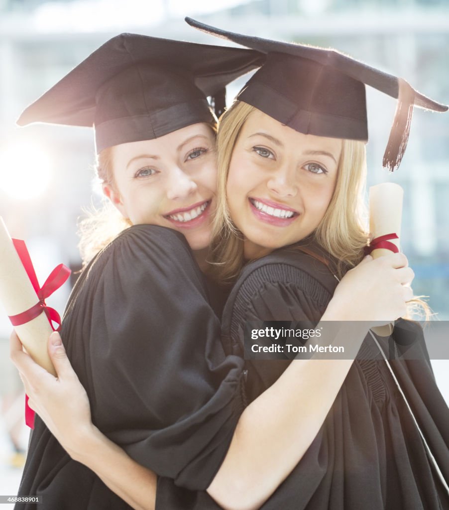Smiling graduates hugging