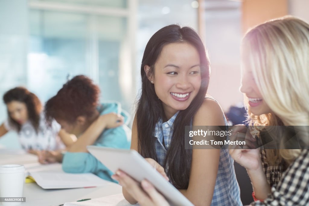 University students using digital tablet in classroom