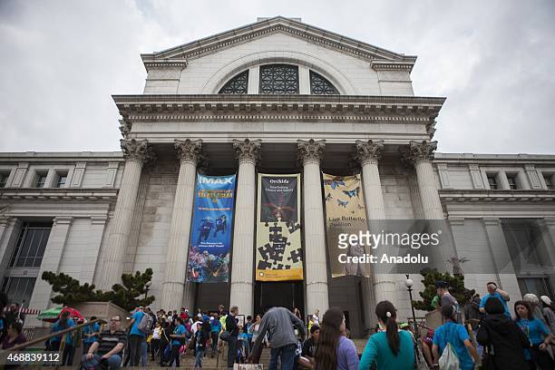 People wait outside the Smithsonian Natural History Museum which was closed due to a power outage that hit most of the city in Washington, USA on...