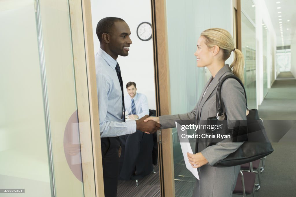 Business people shaking hands in office