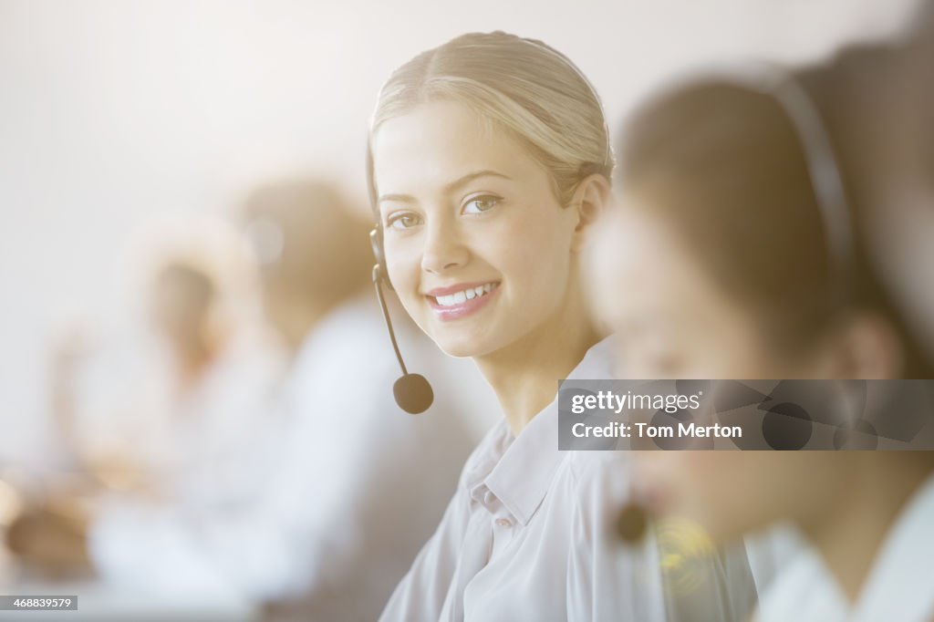 Businesswoman wearing headset in office