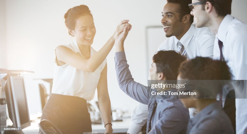 Business people cheering in office