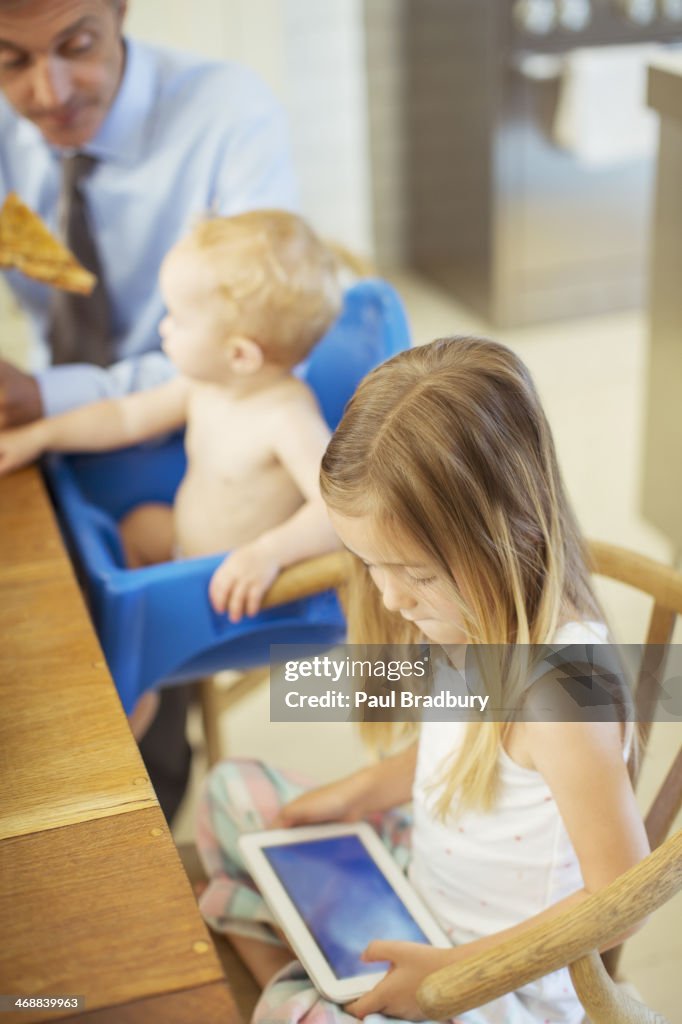 Girl using digital tablet at table