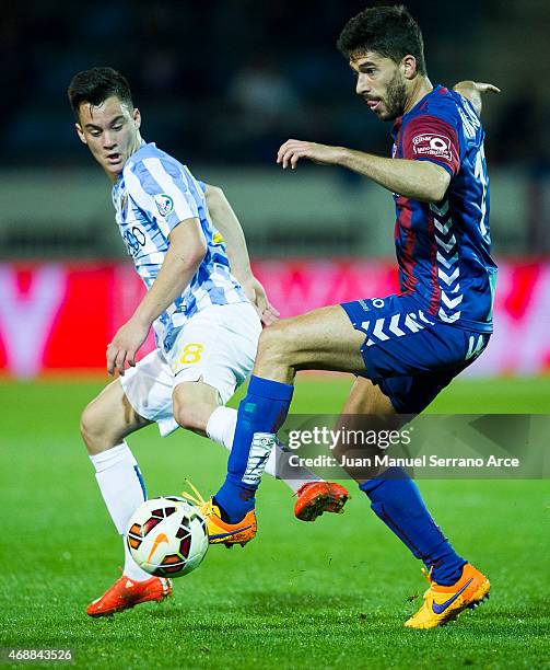 Juan Pablo Anor of Malaga FC duels for the ball with Didac Vila of SD Eibar during the La Liga match between SD Eibar and Malaga FC at Ipurua...