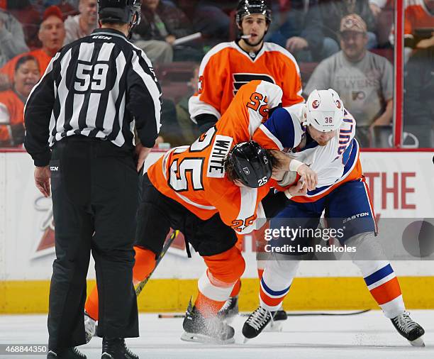 Ryan White of the Philadelphia Flyers fights Eric Boulton of the New York Islanders in the first period on April 7, 2015 at the Wells Fargo Center in...