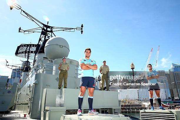 Nick Phipps and Dave Dennis of the Waratahs pose with Warrant Officer Nadia McCulloch and Major Andrew McCulloch on-board the HMAS Vampire during a...