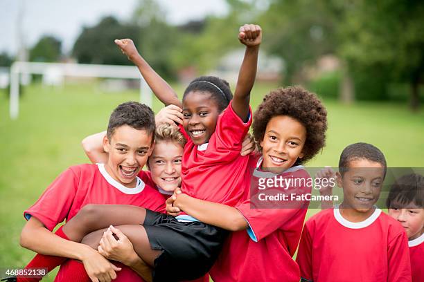 soccer team victory - playing sports stock pictures, royalty-free photos & images