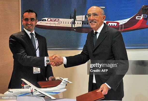 Khalifa AlDaboos , managing director of Dubai Aerospace shakes hands with ATR chief executive Filippo Bagnato at a signing ceremony during the...