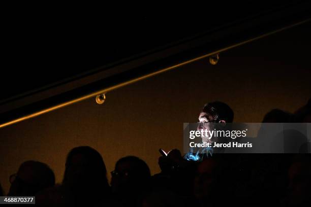 Man uses his smart phone following a special screening of 'Philomena' and conversation with Philomena Lee at the Museum Of Tolerance on February 11,...