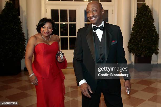 Kenneth Frazier, president and chief executive officer of Merck and Co., right, and his wife Andrea Frazier arrive at a state dinner hosted by U.S....