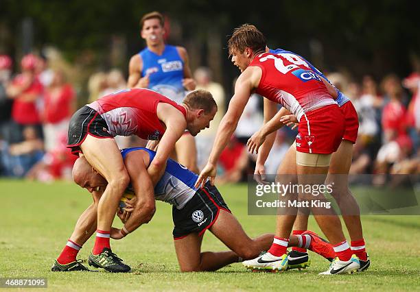 Jarrad McVeigh is wrapped up by Ryan O'Keefe during the Sydney Swans AFL intra-club match at Lakeside Oval on February 12, 2014 in Sydney, Australia.