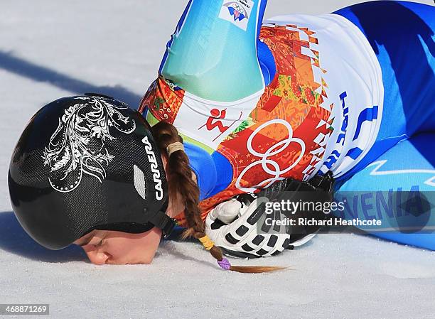 Tina Maze of Slovenia kisses the ground after her run during the Alpine Skiing Women's Downhill on day 5 of the Sochi 2014 Winter Olympics at Rosa...