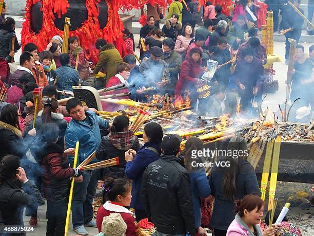 People burn incenses and pray during Kwan-yin's birthday at Nanhai temple on April 7, 2015 in Zhumadian, Henan province of China. February 29 in...