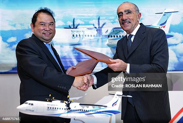 Puttipong Prasarttong-Osoth , President of Bangkok Airways and ATR's Chief Executive Officer Filippo Bagnato , exchange a signed agreement at the...