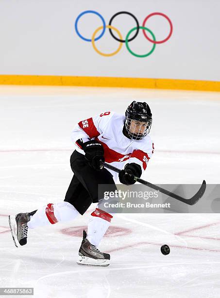 Stefanie Marty of Switzerland shoots the puck against Finland during the Women's Ice Hockey Preliminary Round Group A game on day five of the Sochi...