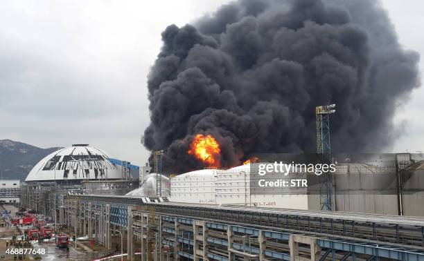 Firefighters battle a blaze following an explosion at a plant producing paraxylene - a chemical commonly known as PX - in Zhangzhou, east China's...