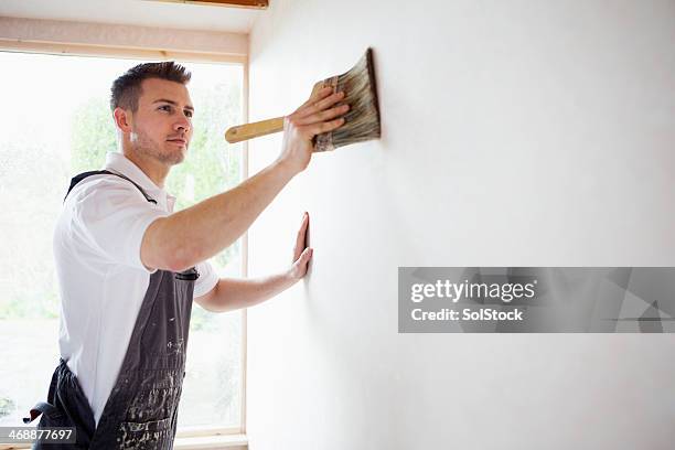 concentrating while decorating - house painting stock pictures, royalty-free photos & images
