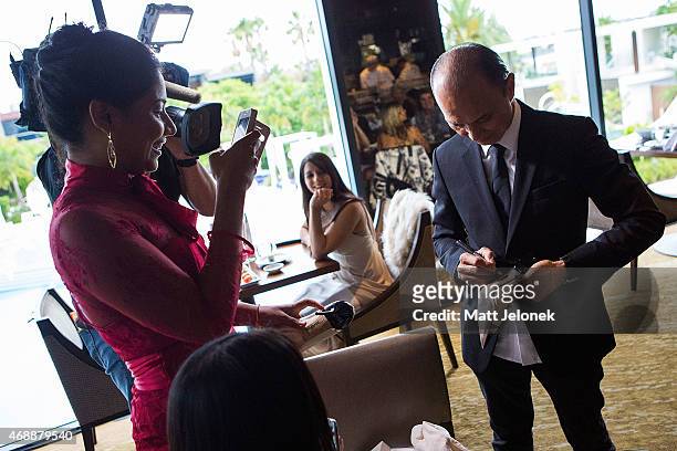 Designer Jimmy Choo signs a shoe at the 'Dine With Professor Jimmy Choo' lunch at Nobu Perth at Crown on April 8, 2015 in Perth, Australia.