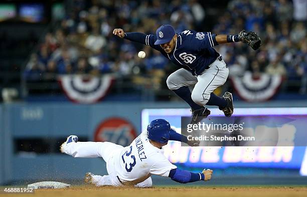 Shortstop Alexi Amarista of the San Diego Padres loses the ball as he attempts to throw to complete a double play after forcing out Adrian Gonzalez...