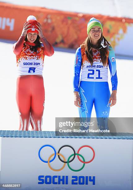 Gold medalists Dominique Gisin of Switzerland and Tina Maze of Slovenia look on during the flower ceremony for during the Alpine Skiing Women's...