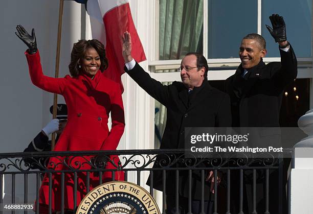 From left First Lady Michelle Obama, President Francois Hollande of France with President Barack Obama wave from the balcony following a ceremony...