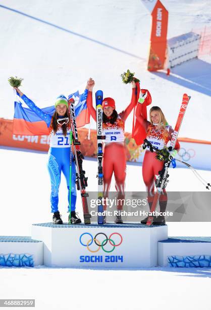 Gold medalist Tina Maze of Slovenia, gold medalist Dominique Gisin of Switzerland and bronze medalist Lara Gut of Switzerland celebrate on the podium...