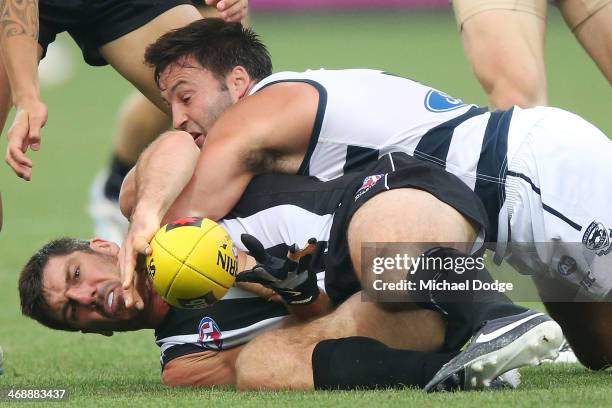 Quinten Lynch of the Magpies is tackled by Jimmy Bartel of the Cats during the round one AFL NAB Cup match between the Geelong Cats and the...