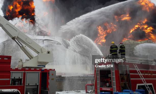 Firefighters battle a blaze following an explosion at a plant producing paraxylene - a chemical commonly known as PX - in Zhangzhou, east China's...