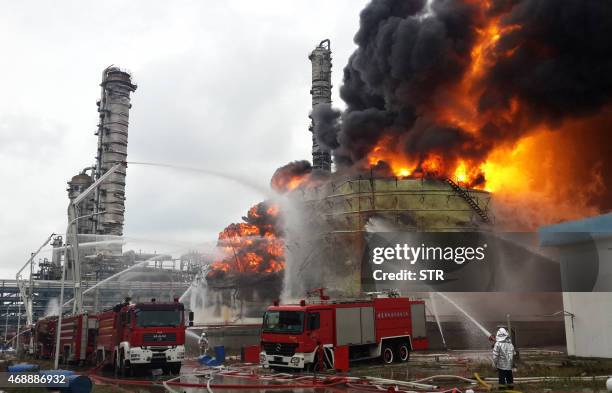 Firefighters battle a blaze following an explosion at a plant producing paraxylene - a chemical commonly known as PX - in Zhangzhou, east China's...