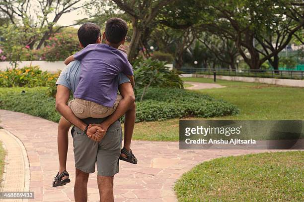 man carrying his son on his back - おんぶ ストックフォトと画像