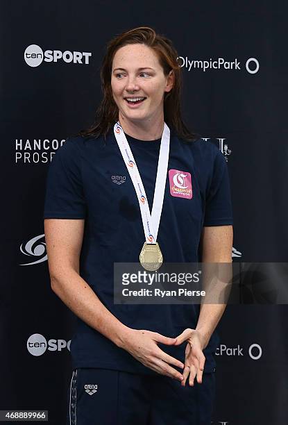 Cate Campbell of Australia celebrates on the podium after winning the Womens 100m Freestyle Final during day six of the Australian National Swimming...