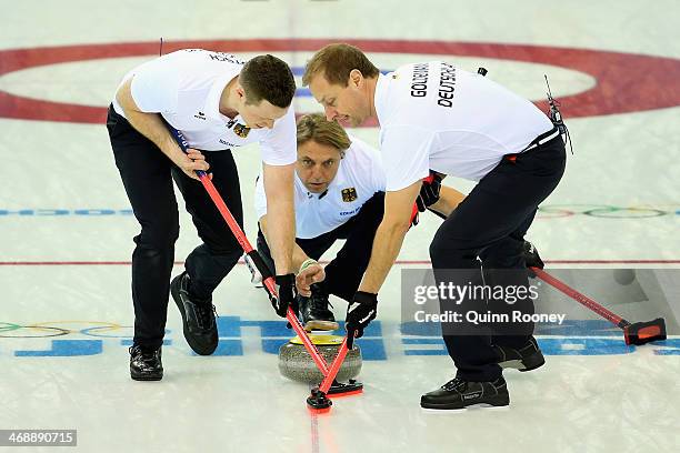 Teammates Christopher Bartsch,John Jahr and Sven Goldemann of Germany compete in the Curling Men's Round Robin match between Norway and Germany...