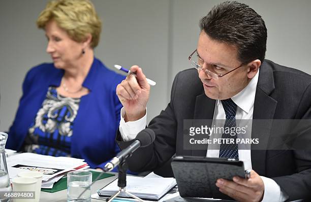 Australian Senator Nick Xenophon grills executives from Apple, Google and Microsoft at an Australian parliamentary hearing in Sydney on April 8,...