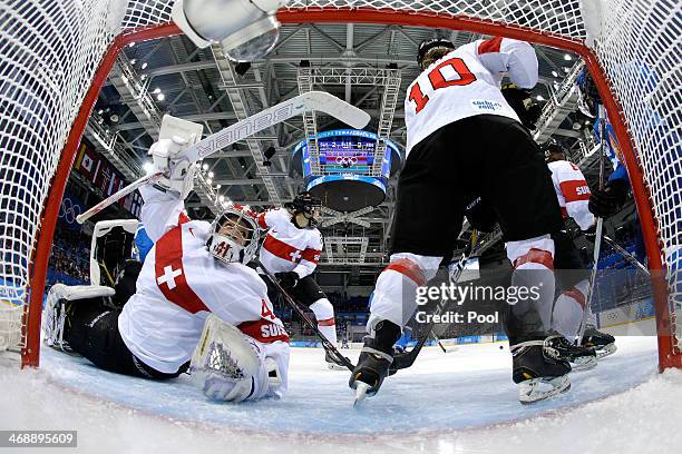 Nicole Bullo of Switzerland clears the puck out of the net against Hanna-Riika Valila of Finland during the Women's Ice Hockey Preliminary Round...