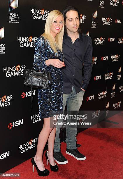 Actress Tara Reid and Erez Eisen attend the premiere of Sony Pictures Home Entertainment's "The Hungover Games" at TCL Chinese 6 Theatres on February...