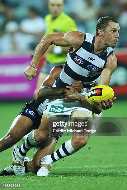 James Kelly of the Cats looks to handpass the ball during the round one AFL NAB Cup match between the Geelong Cats and the Collingwood Magpies at...