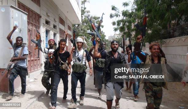 Yemeni fighters opposing the Huthi rebels shout slogans as they walk in the southern Yemeni city of Aden on April 8, 2015 as clashes continue to rage...