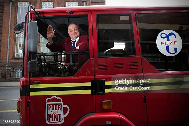 Alastair James Hay, better known as comedian 'Al Murray' who portrays an English pub landlord, arrives in a converted fire engine to hand in his...