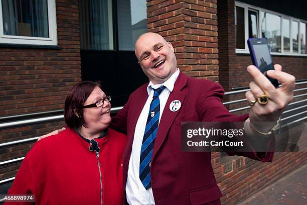 Alastair James Hay, better known as comedian 'Al Murray' who portrays an English pub landlord, takes a selfie photograph with a fan after handing in...