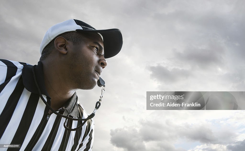 Arbitro mandare Whistle durante una partita di Football americano