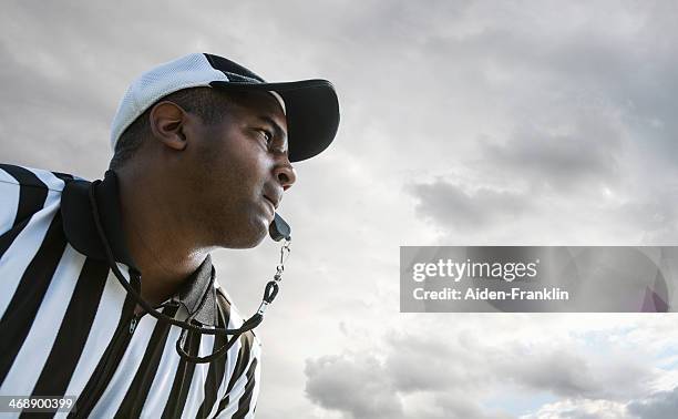 referee blowing whistle during football game - referee portrait stock pictures, royalty-free photos & images