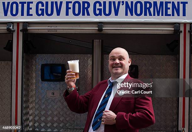 Alastair James Hay, better known as comedian 'Al Murray' who portrays an English pub landlord, poses with a pint of beer poured from a fire engine...