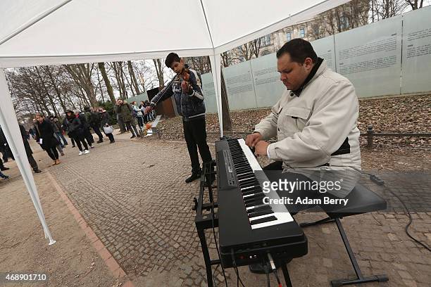 Musicians perform outside the Memorial to the Sinti and Roma of Europe Murdered Under National Socialism on International Romani Day on April 8, 2015...