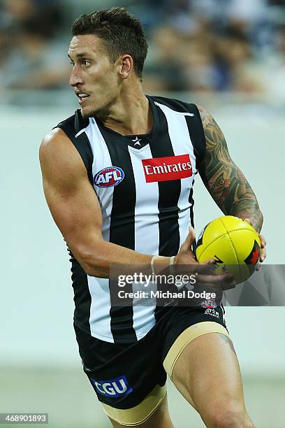 Jesse White of the Magpies runs with the ball during the round one AFL NAB Cup match between the Geelong Cats and the Collingwood Magpies at Simonds...