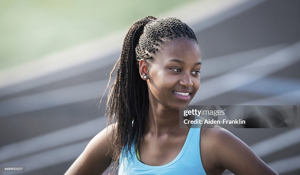 High School Athlete Smiling After Winning Race During Track Event