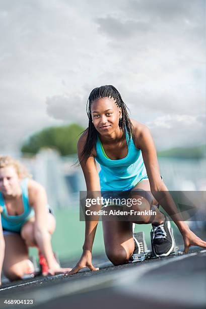 confident african american athletic student at starting line of race - girls on train track stock pictures, royalty-free photos & images